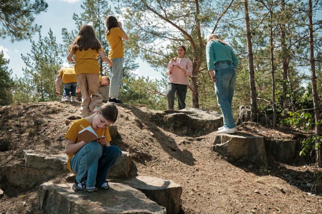Outdoor Forest School students engaging in reflective learning on beautiful hiking trails
